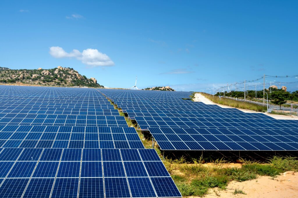Vast solar panel field under blue sky
